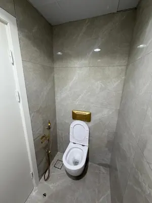 a small bathroom with a toilet in a stall at Heart of Marina with Free Parking, Pool and Gym in Dubai