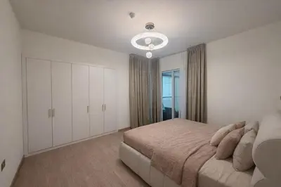 a bedroom with a bed and a large window at Heart of Marina with Free Parking, Pool and Gym in Dubai