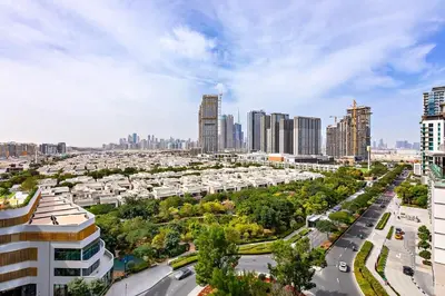 an aerial view of a city with tall buildings at 1B with Park and Burj Khalifa View, Hartland Waves in Dubai