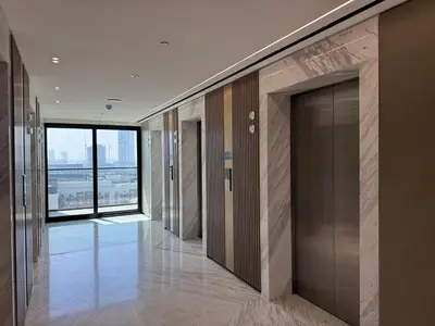 an empty hallway with glass doors in a building at Elegant 1BR Living at Binghatti Emerald in Dubai