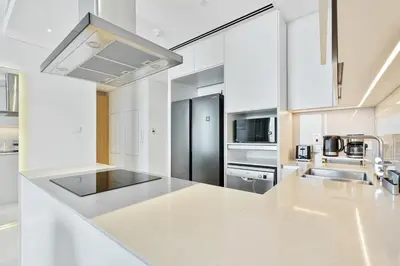 a kitchen with white counter tops and stainless steel appliances at Elegant 3 bed Haven in Address JBR Tower 1 in Dubai