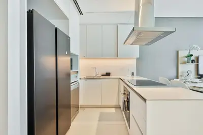 a kitchen with a stainless steel refrigerator at Elegant 3 bed Haven in Address JBR Tower 1 in Dubai