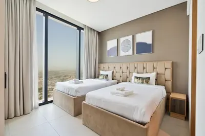 two beds in a hotel room with large windows at Elegant 3 bed Haven in Address JBR Tower 1 in Dubai
