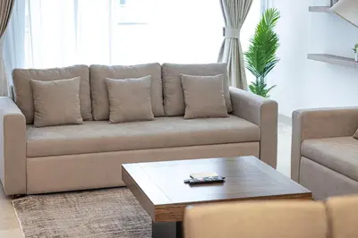 a living room with a couch and a coffee table at Trident Grand! Near Beach, Pool and Gym Access! In JBR-Dubai Marina in Dubai