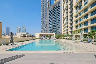 a swimming pool in the middle of a building at Silkhaus Luxurious 1BR with Balcony Pool and Gym Downtown in Dubai