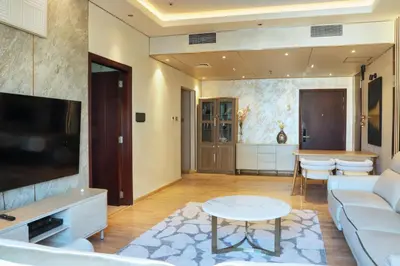 a living room with a couch and a table at 902, Royal Residencies, Dubai Sports City in Dubai