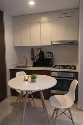 a kitchen with a table and chairs and a stove at Burj Khalifa View Stylish 1BR in Business Bay in Dubai