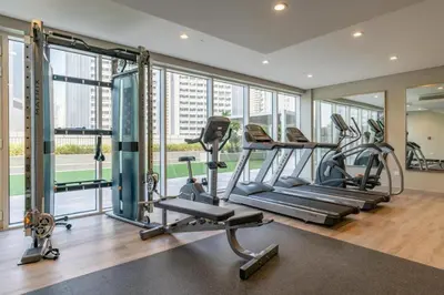 a gym with treadmills and ellipticals in a building at Burj Khalifa View Stylish 1BR in Business Bay in Dubai