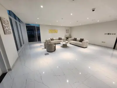 a large living room with couches and a table at Skyz by Danube, Brand new Studios in Arjan in Dubai