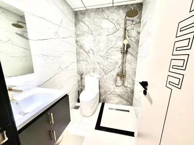 a bathroom with a toilet and a sink at Skyz by Danube, Brand new Studios in Arjan in Dubai