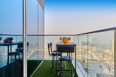 a table and chairs on the balcony of a building at 1BR 42nd Floor Palm Jumeriah & Sea View- 5 Sleeps in Dubai
