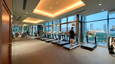 a gym with rows of treadmills in a building at Burj Vista! Great High Floor View! Mall Connected! Amazing Pool, Gym and Location! in Dubai