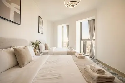 a white room with a bed and a couch at Burj Vista! Great High Floor View! Mall Connected! Amazing Pool, Gym and Location! in Dubai