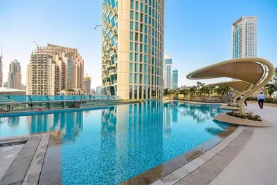 a large swimming pool in a city with tall buildings at Burj Vista! Great High Floor View! Mall Connected! Amazing Pool, Gym and Location! in Dubai