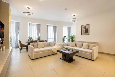 a living room with a couch and a table at Burj Vista! Great High Floor View! Mall Connected! Amazing Pool, Gym and Location! in Dubai