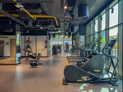 a gym with cardio equipment in a building at Modern 2Bed with Iconic Burj Khalifa & Canal Views in Dubai