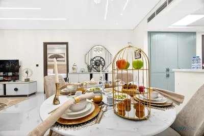 a living room with a table with food on it at Enchanted 1BR Royal Amwaj Burj View & Private Beach in Dubai