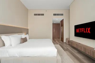 a hotel room with a bed and a television at Westminster Imperial Avenue Downtown in Dubai