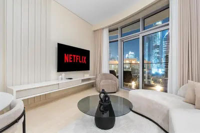 a living room with a tv and a couch at Westminster Imperial Avenue Downtown in Dubai