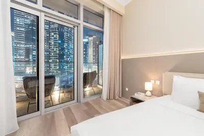 a bedroom with a bed and a large window at Westminster Imperial Avenue Downtown in Dubai