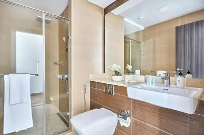 a bathroom with a sink and a toilet and a shower at Frank Porter - Sparkle Tower 1 in Dubai