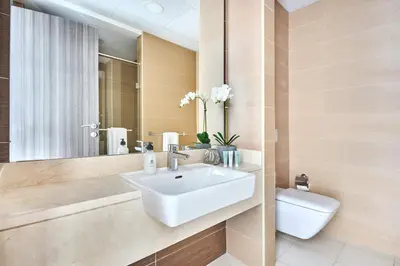a bathroom with a sink and a toilet at Frank Porter - Sparkle Tower 1 in Dubai