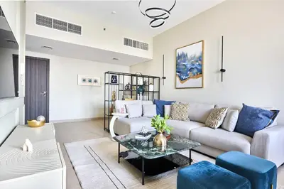a living room with a couch and a table at Frank Porter - Sparkle Tower 1 in Dubai
