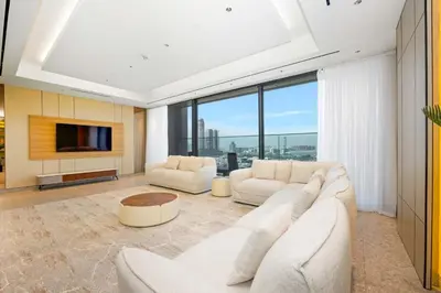 a living room with two white couches and a tv at Stylish 4BR Penthouse with Maids Room & Modern Amenities in Dubai