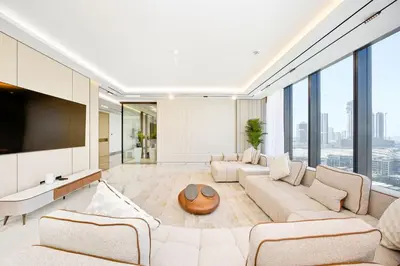 a living room with a couch and a tv at Stylish 4BR Penthouse with Maids Room & Modern Amenities in Dubai