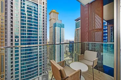 a balcony with a table and chairs and buildings at Elegant 1-Bed Apartment with Premium Comforts in Dubai
