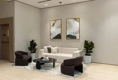 a living room with a white couch and two chairs at Chic 1BR Urban Retreat Binghatti Phantom in Dubai