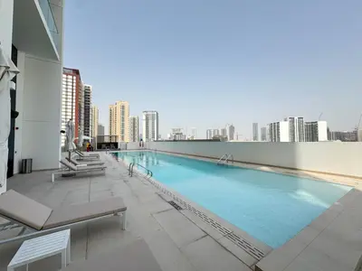 a large swimming pool on the roof of a building at Elegant 2BR Apartment with Private Pool in JVC in Dubai