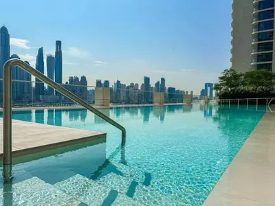 a swimming pool with a view of the city at Prime Waterfront Living with Partial Sea Views, Just a Short Drive from Palm Jumeirah, Marina Vista Tower 1, Emaar Beachfront by Deluxe Holiday Homes in Dubai