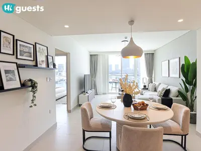 a kitchen and living room with a table and chairs at HiGuests - Beautiful Sea Facing 1BR at Emaar Beachfront in Dubai