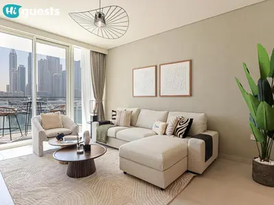 a living room with a couch and a table at HiGuests - Beautiful Sea Facing 1BR at Emaar Beachfront in Dubai