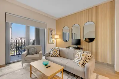 a living room with a couch and a table at Stylish Chic 1BR with Lagoons Access - Creek Beach in Dubai
