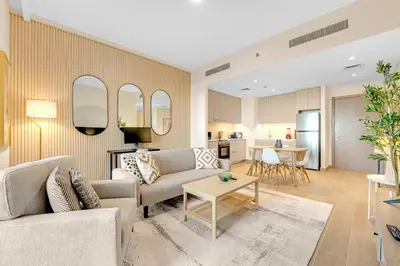 a living room with two couches and a table at Stylish Chic 1BR with Lagoons Access - Creek Beach in Dubai