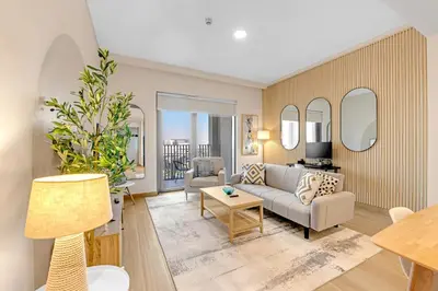 a living room with a couch and a table at Stylish Chic 1BR with Lagoons Access - Creek Beach in Dubai