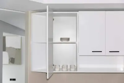 a white kitchen with white cabinets at Penthouse Vibes 3BR Billiard & Air Hockey in Dubai