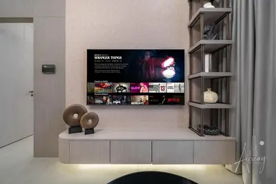 a living room with a tv on the wall at Sweet Escape 1BR in JVC Near Circle Mall in Dubai