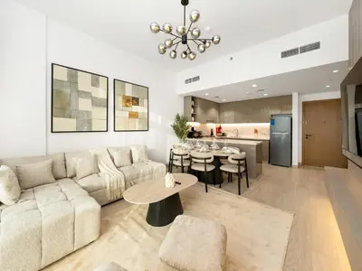 a living room with a couch and a table at Stunning 2BR at Azizi Amber Sleeps 5 in Dubai