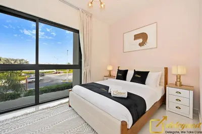 a bedroom with a bed and a large window at Signature 3BR Maid Villa DH2 by Deleguest in Dubai