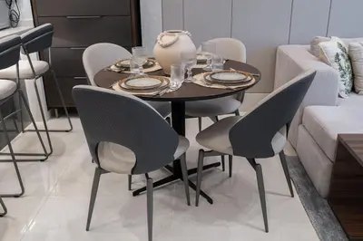 a dining room table with chairs and a vase on it at Boutique 1BHK at Nobles Tower By Czechin in Dubai