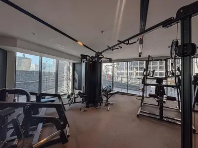 a gym with treadmills and machines in a building at Boutique 1BHK at Nobles Tower By Czechin in Dubai