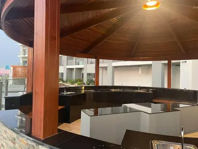 an outdoor kitchen with black and white counter tops at Classy Studio ideal for long stays with balcony in Dubai