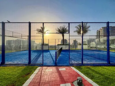 a fence in front of a swimming pool at Classy Studio ideal for long stays with balcony in Dubai