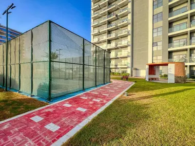 a batting cage in front of a building at Classy Studio ideal for long stays with balcony in Dubai