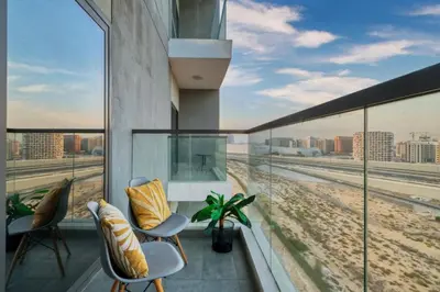 a balcony with chairs and a view of the beach at Classy Studio ideal for long stays with balcony in Dubai