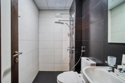 a bathroom with a shower and a toilet and a sink at Studio in Liwan for long stays 1005 in Dubai