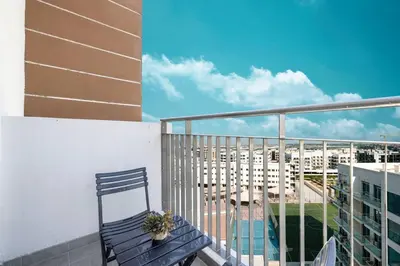 a balcony with a bench and a view of a building at New studio in Arjan ideal for long stays in Dubai